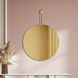Golden round mirror on a...